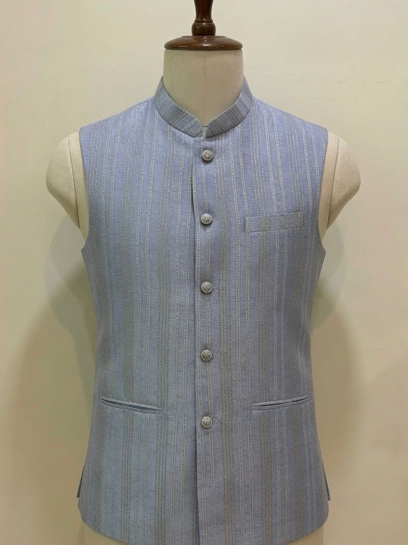 A light blue and white vertically striped Sabhyashree waistcoat vest displayed on a cream-colored mannequin torso against a plain beige background.